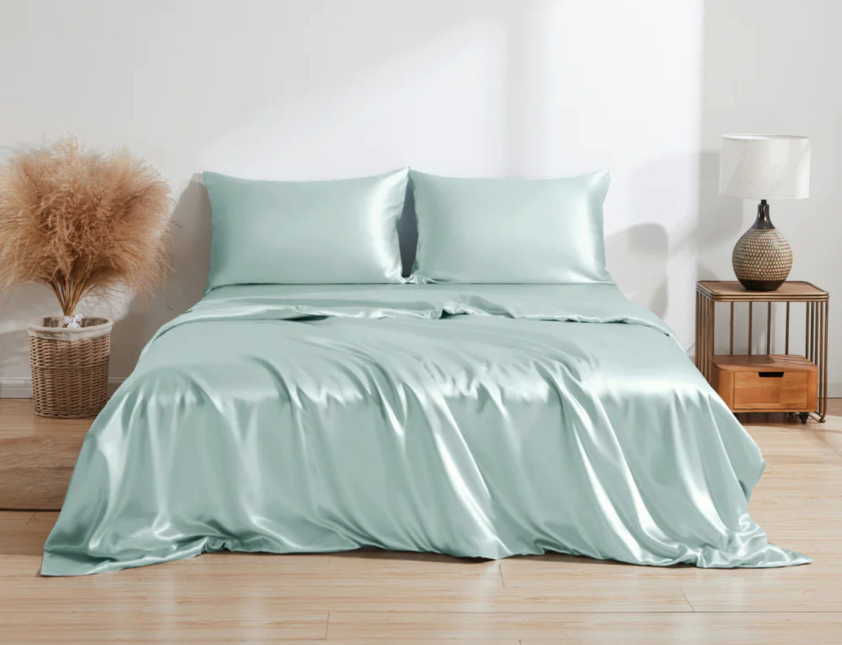 Luxurious Slumber: Experience the ultimate comfort and indulgence with our best-selling silk bedding. Drift into a world of relaxation as you sink into a bed adorned with a green silk sheet.