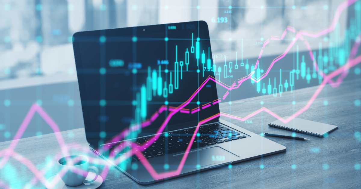 Open laptop on a desk, displaying a financial graph overlayed with pink and blue lines, illustrating an Amazon e-commerce journey. A cup of coffee, notebook, and pen are also on the desk.