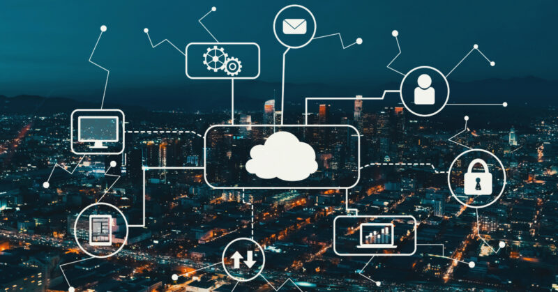 A city at night with a cloud infrastructure in the sky, managing entitlements.
