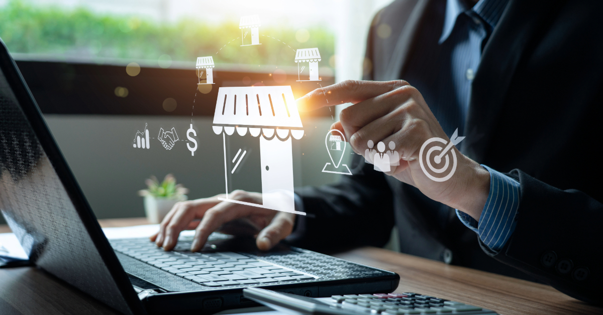 A person uses a laptop while touching virtual icons, including a storefront, dollar signs, shopping carts, and target symbols, illustrating e-commerce store and business concepts. The image captures the efficiency of same day delivery in the modern digital marketplace.