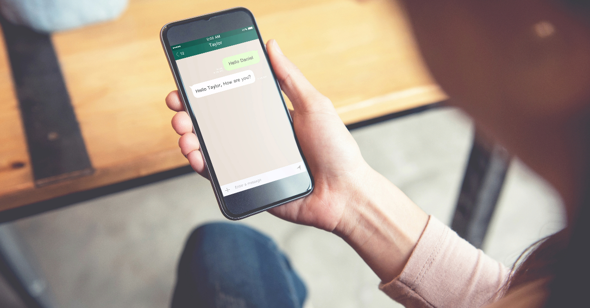 A woman solving a text message on her smartphone.