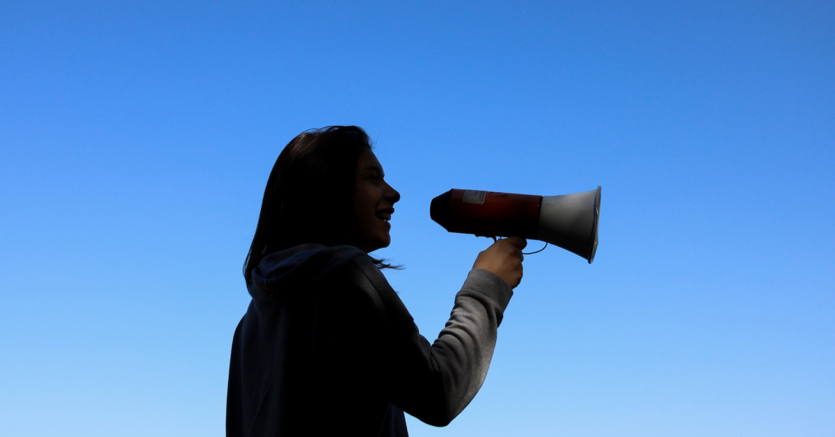 A silhouette of a woman holding a megaphone against a blue sky, representing the brand's presence in the competitive e-commerce market.