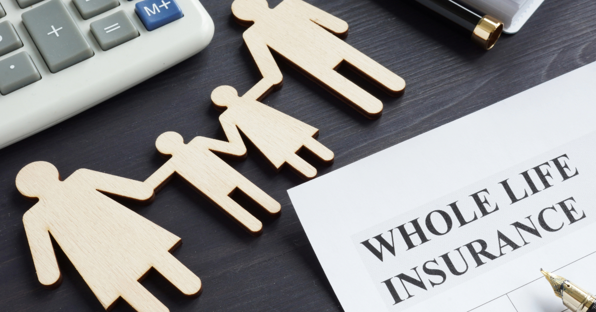 Wooden family figurines, a calculator, and a document titled "Whole Life Insurance" are arranged on a dark surface, illustrating one of the many insurance types available.