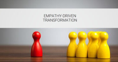 A red game piece is separated from a group of yellow game pieces on a wooden surface, with the text "Empathy-Driven Transformation" above, illustrating the power of human-centric design in fostering understanding and innovation.
