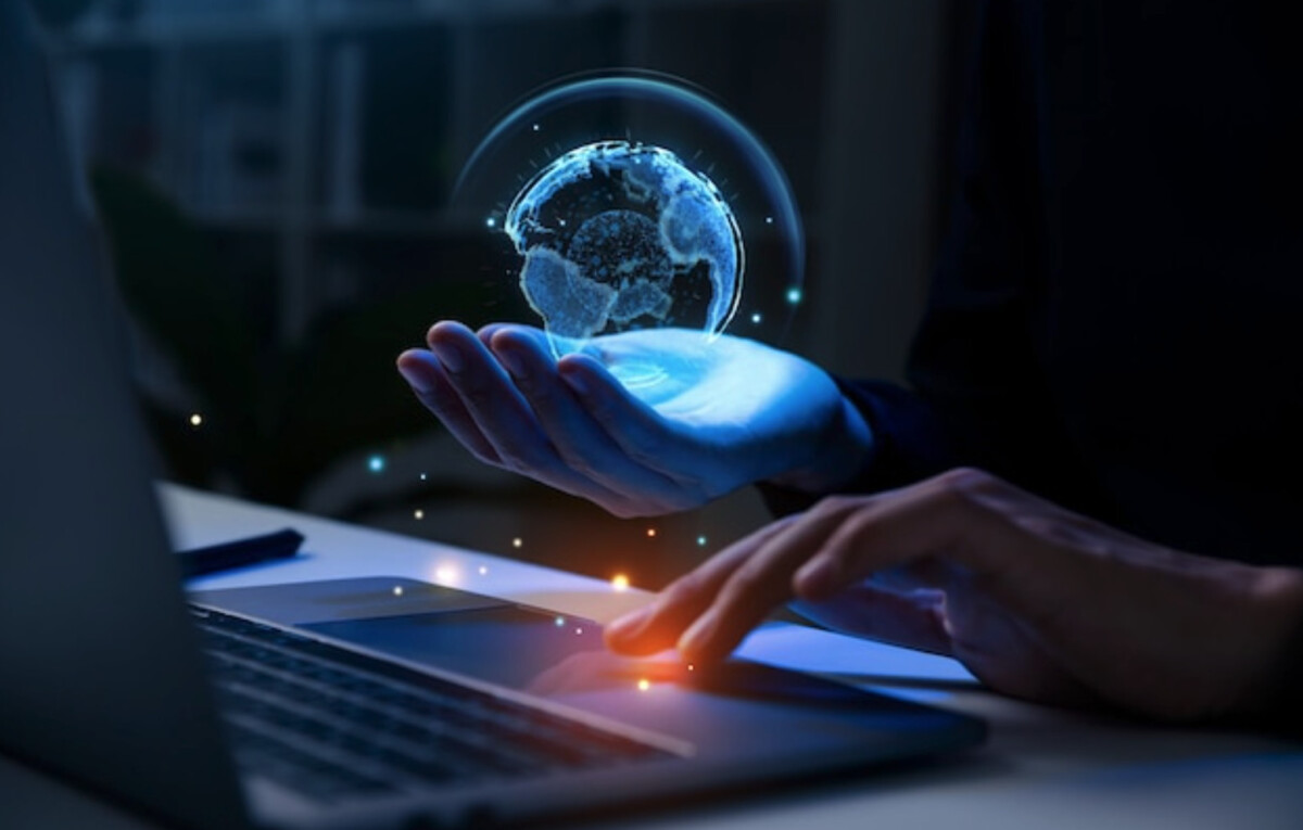 A person navigates the digital era with ease, using a laptop as a holographic globe hovers above their hand—a seamless blend of technology and endless possibilities in logistics.