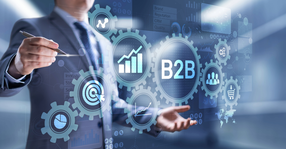 A person in a suit engages with digital gears showcasing "B2B" alongside various business-related icons and graphs, highlighting B2B brand awareness strategies crucial for eCommerce businesses.