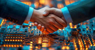 Two people in business suits shake hands over a glowing circuit board, symbolizing a partnership or agreement in technology between leaders like AMD and Samsung.