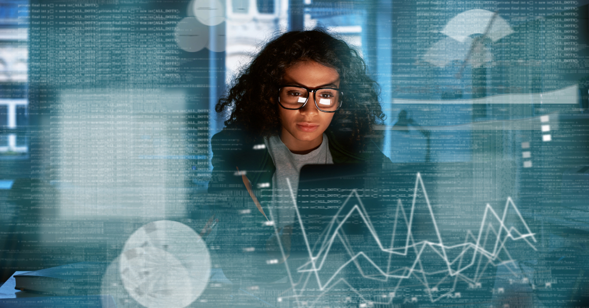A woman wearing glasses looks at a computer screen displaying ecommerce statistics and AI-driven data graphs in a technology-focused office environment.