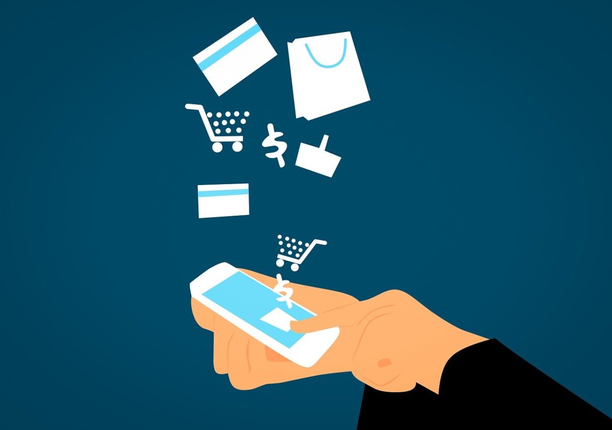 A hand holds a smartphone with icons of shopping bags, carts, and credit cards floating above, representing online shopping and the latest 2024 ecommerce tech stack for mobile payments.