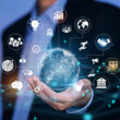 A person in a suit holds a digital globe with interconnected business, technology, and communication icons—symbolizing global expansion and seamless market entry.