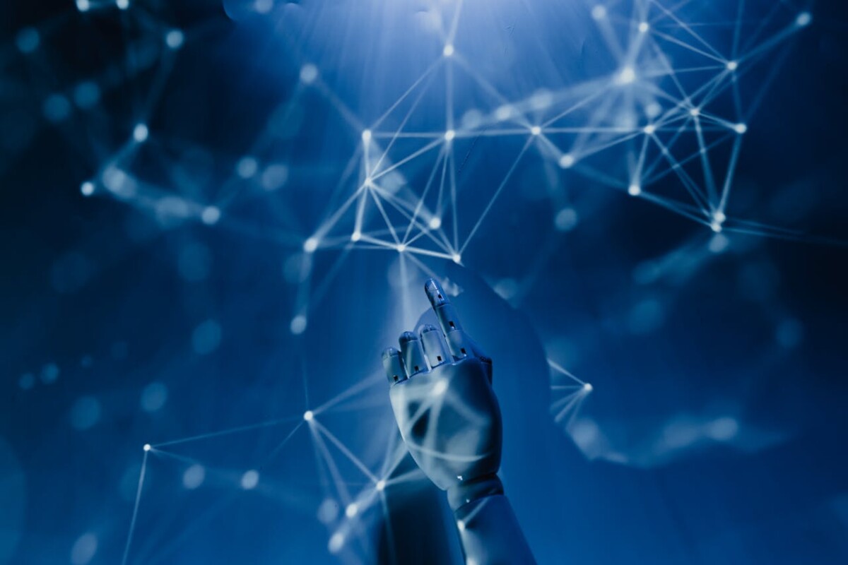 A robotic hand reaches toward a network of glowing, interconnected points against a blue digital background, symbolizing the journey of overcoming RPA challenges during successful RPA deployment.