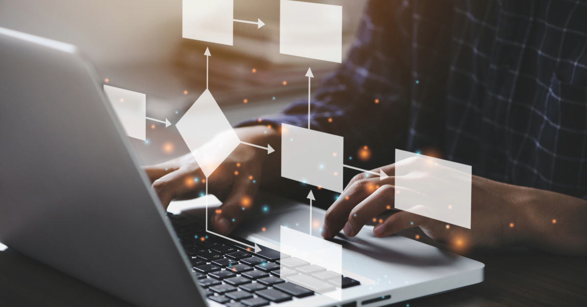 Person typing on a laptop with flowchart graphics and arrows digitally overlaid, highlighting the use of essential business tools for process planning or workflow design.
