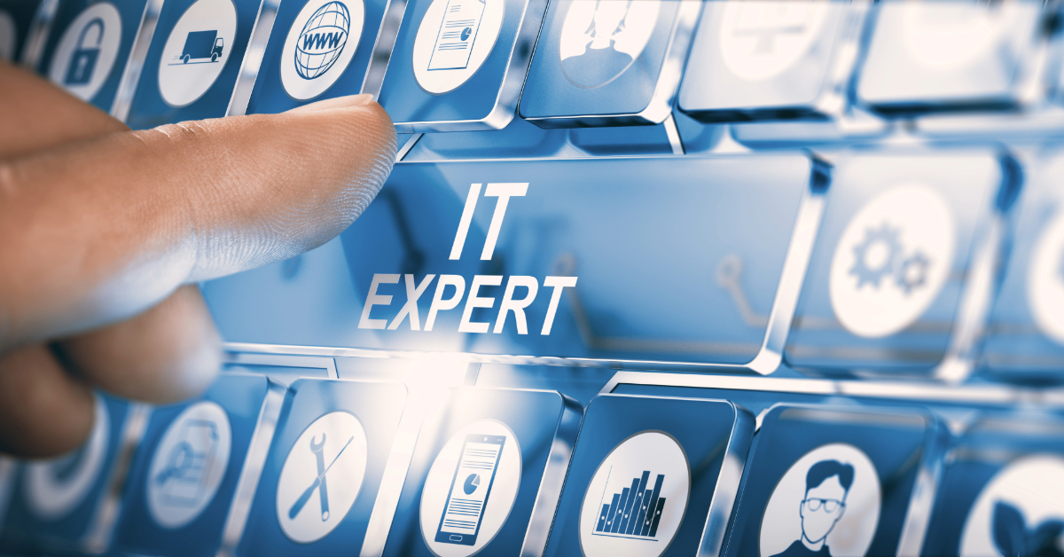 A finger pressing a keyboard key labeled "IT Expert" among various technology and business-related icons, symbolizing IT Consulting expertise.