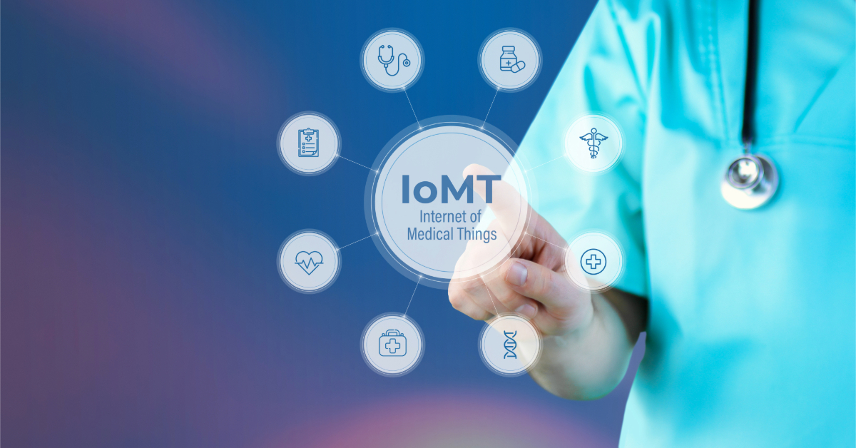 A person in medical scrubs interacts with a transparent screen displaying "IoMT Internet of Medical Things," illustrating how IoT technology is transforming healthcare with smart, connected devices.