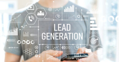 Person holding a smartphone with digital icons and graphs overlaid, centered around the text "Lead Generation Strategies"—ideal for startups seeking effective lead generation.