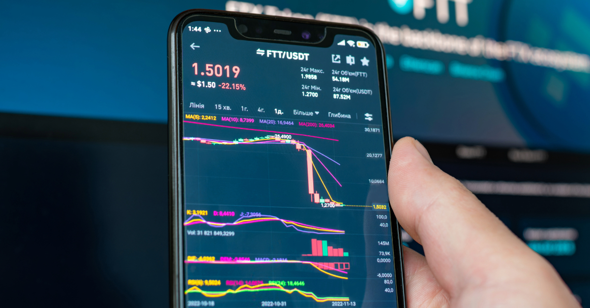 A hand holds a smartphone displaying a sharp decline in the FTT/USDT cryptocurrency price chart, with red and yellow indicators and financial data visible—highlighting market volatility similar to recent ETH to MATIC swap trends.