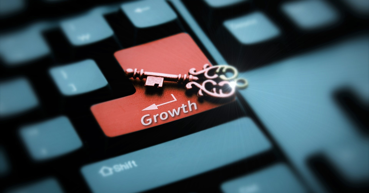 A vintage key rests on a red keyboard key labeled "Growth" with a white arrow, symbolizing the concept of unlocking your Store Growth.