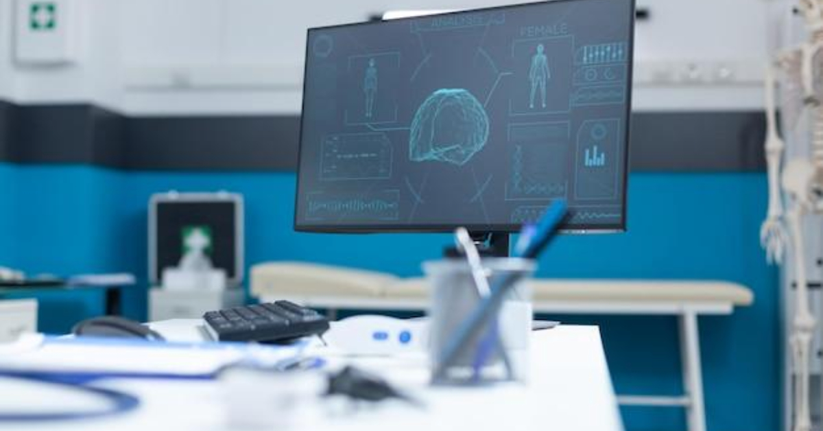 A computer monitor in a medical office displays a brain scan and related data powered by AI; medical instruments and supplies are on the desk in the foreground, reflecting innovation in the healthcare industry.