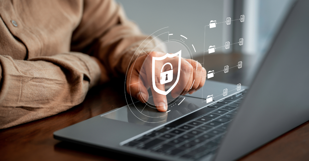 Person using a laptop with a digital lock and shield graphic overlay, symbolizing cybersecurity and data protection for e-commerce, with floating folder icons around the shield.