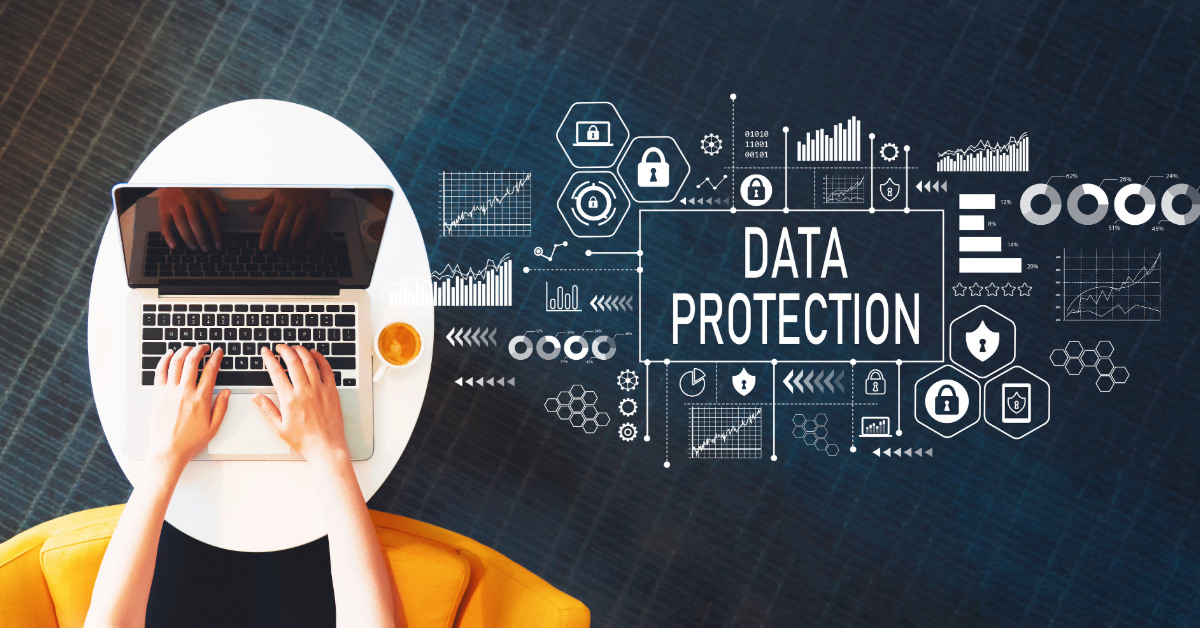 Person typing on a laptop at a round table with digital graphics and the words "Data Protection" displayed on a dark background, highlighting the importance of safeguarding financial assets in 2024.