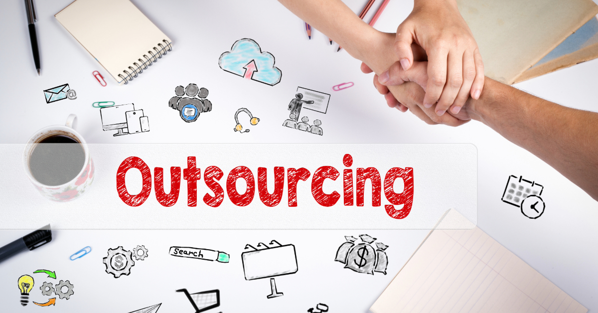 Two people shaking hands over a desk with business-related doodles and the word "Outsourcing" in bold red letters, highlighting outsourcing benefits for ecommerce tasks. Coffee, notebooks, and pens are scattered around the workspace.