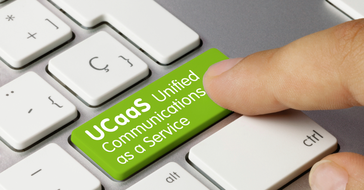 A finger presses a green keyboard key labeled "UCaaS Unified Communications as a Service" on a white computer keyboard, highlighting seamless business communication solutions.