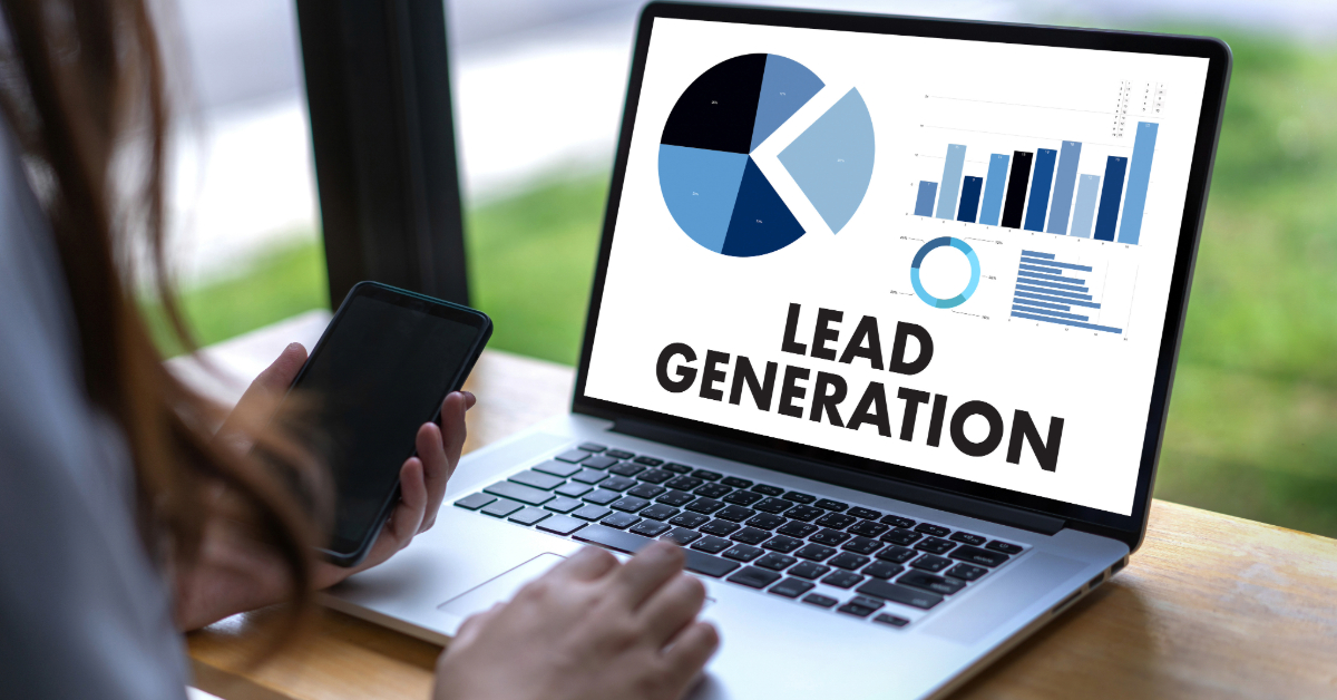 Person using a laptop displaying charts and the words "Lead Generation" on the screen, while holding a smartphone—perfect for showcasing business growth or demand generation strategies.