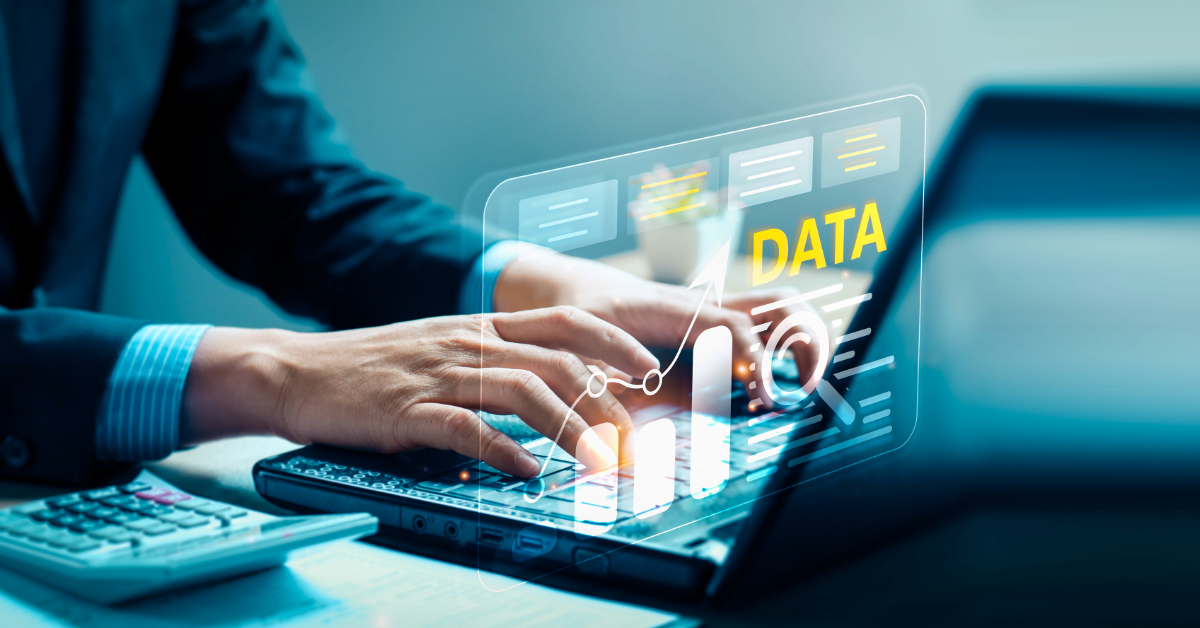 Person typing on a laptop with a calculator nearby, while a digital overlay displays "DATA," various charts, and graphs—highlighting how CDP tools can enhance Customer Experience (CX) through data-driven insights.