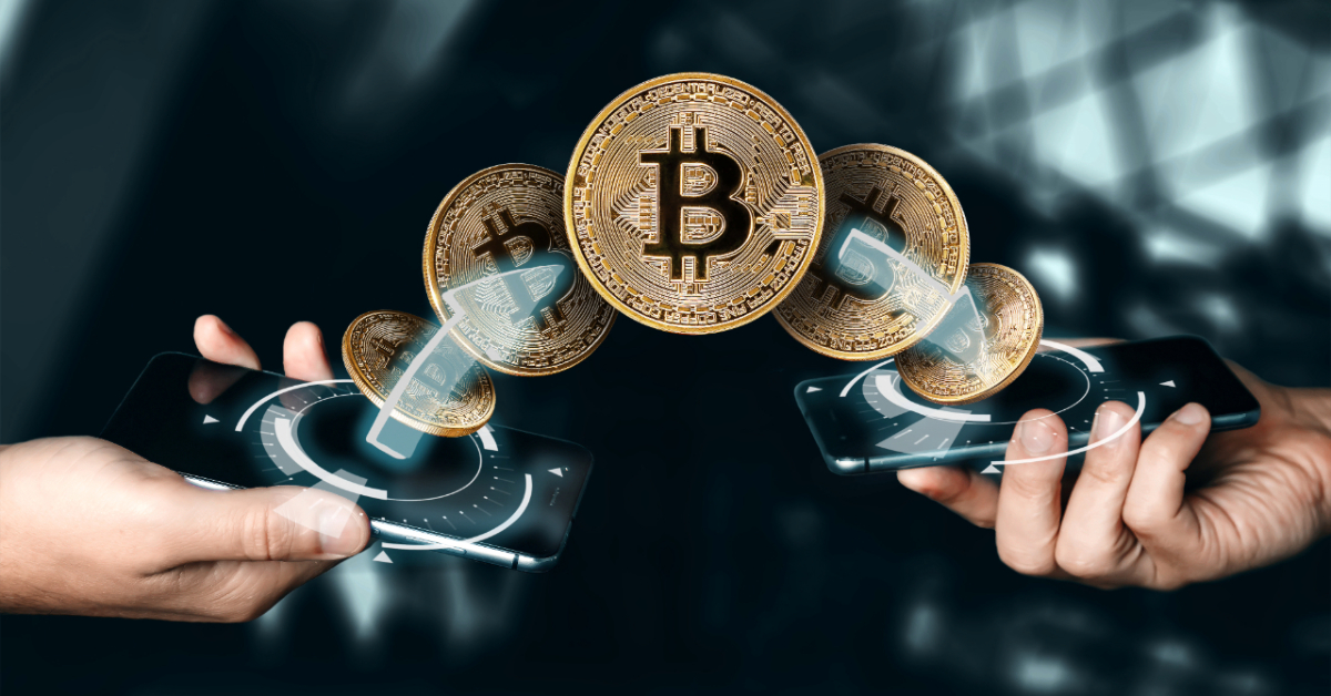 Two hands holding smartphones with digital Bitcoin symbols between them, representing the transfer of cryptocurrency in 2024 and highlighting the importance of crypto security.